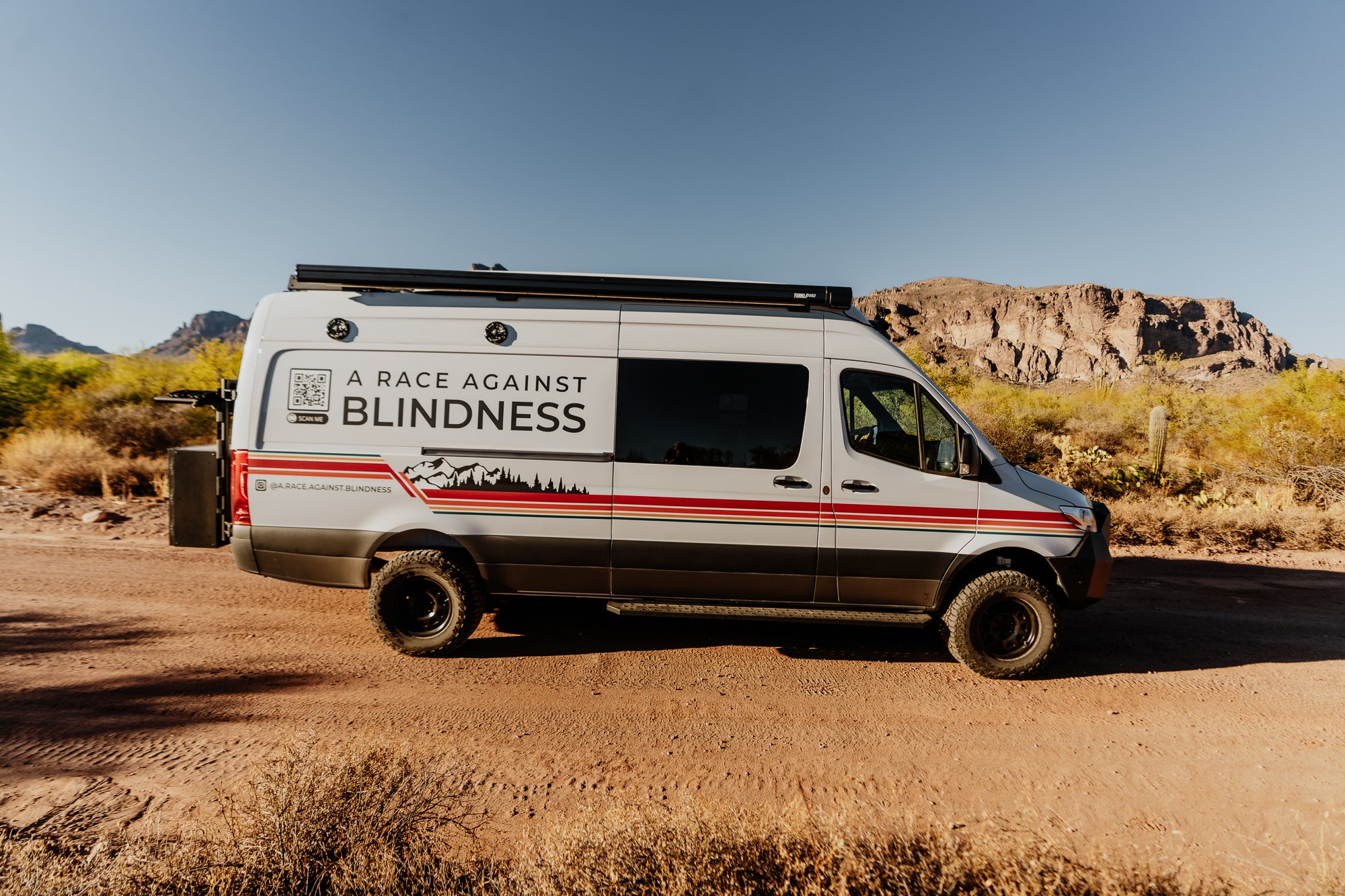 Adventure Van in the desert with A Race Against Blindness decal on the side