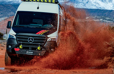 Storyteller Adventure Van splashing through the mud