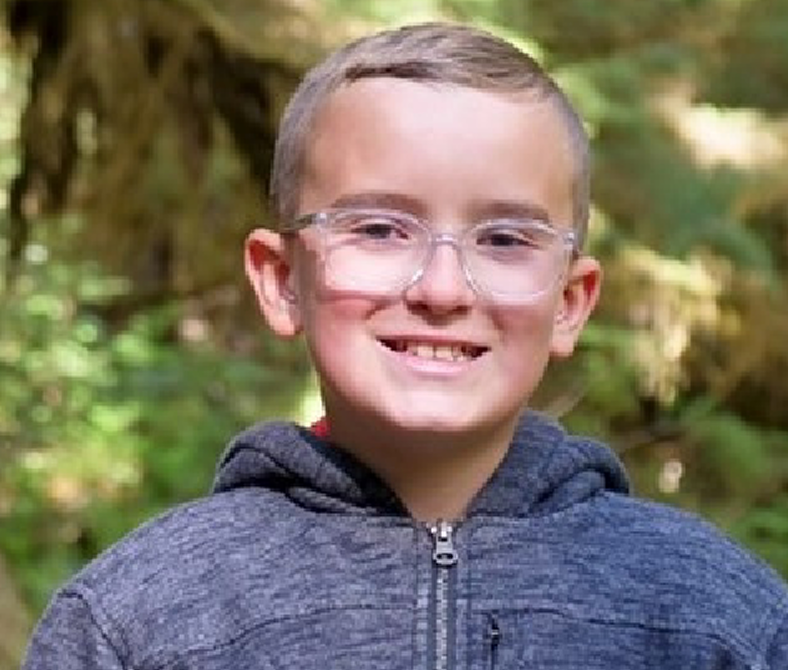 Luke smiling while out hiking