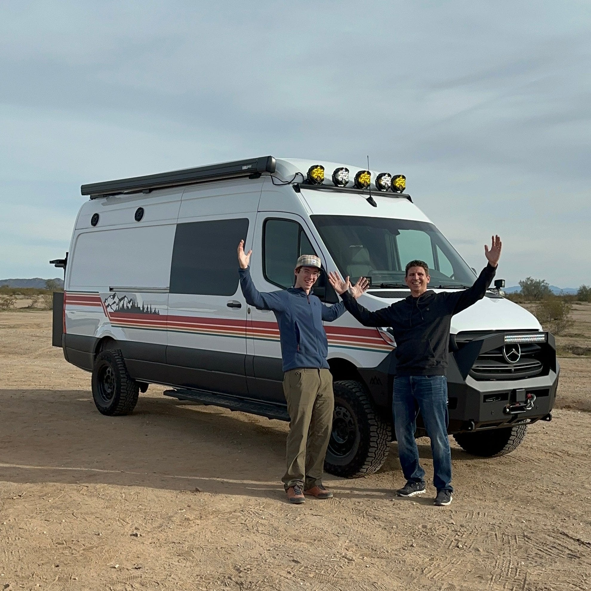 Eric A. and his dad standing in front of the 27North adventure van that he won in the first ever RAB fundraiser.